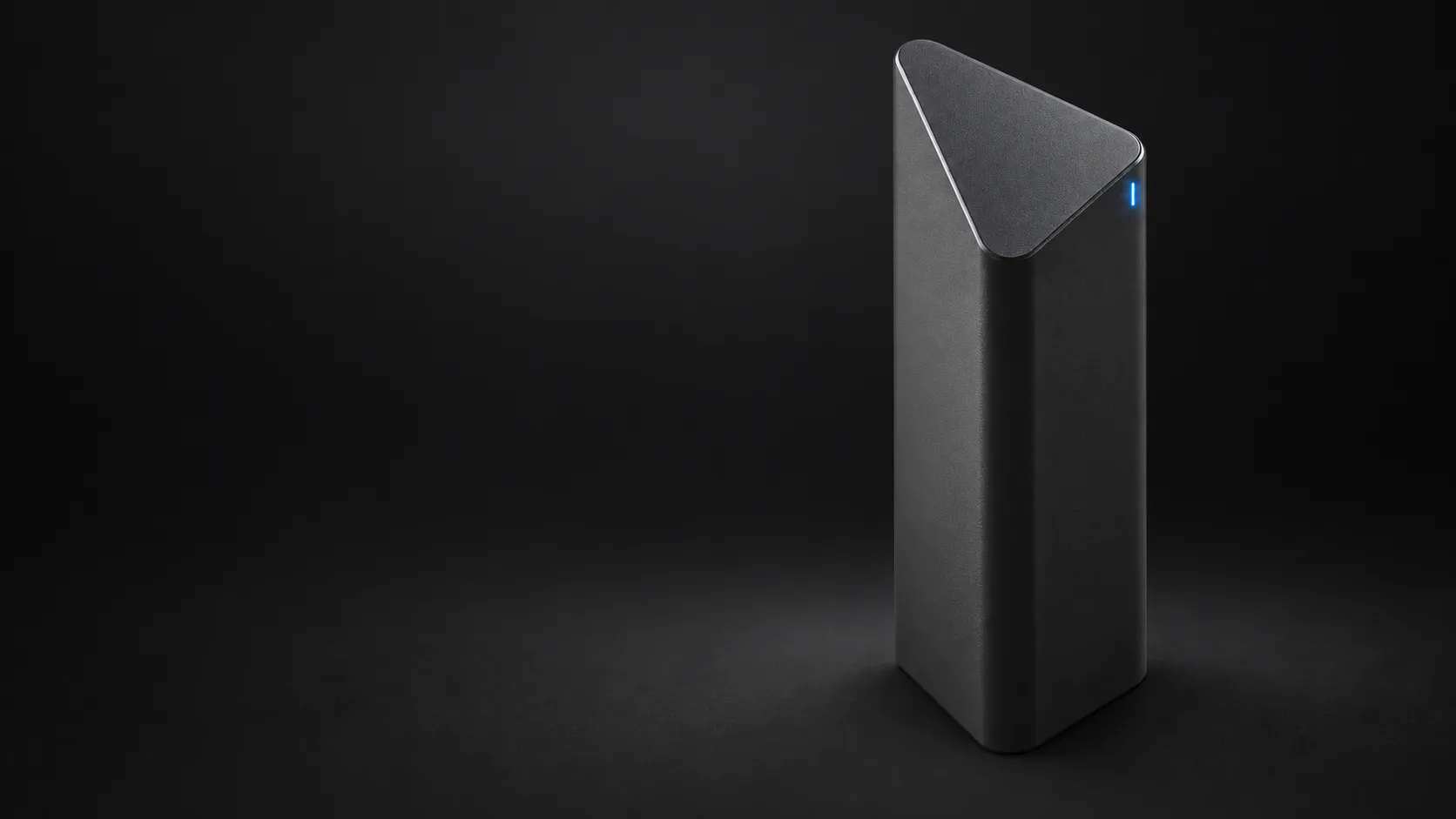 Vaitiq, a tall matte-black triangular device with a slanted top and a single blue indicator light.